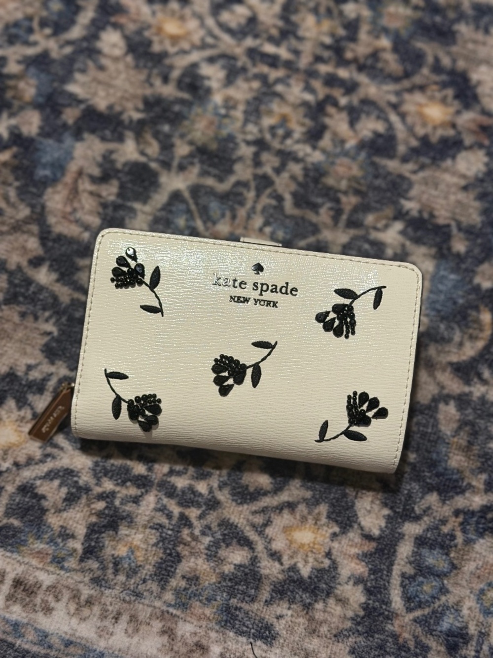 Kate Spade cream compact wallet with black floral embroidery — authentic.